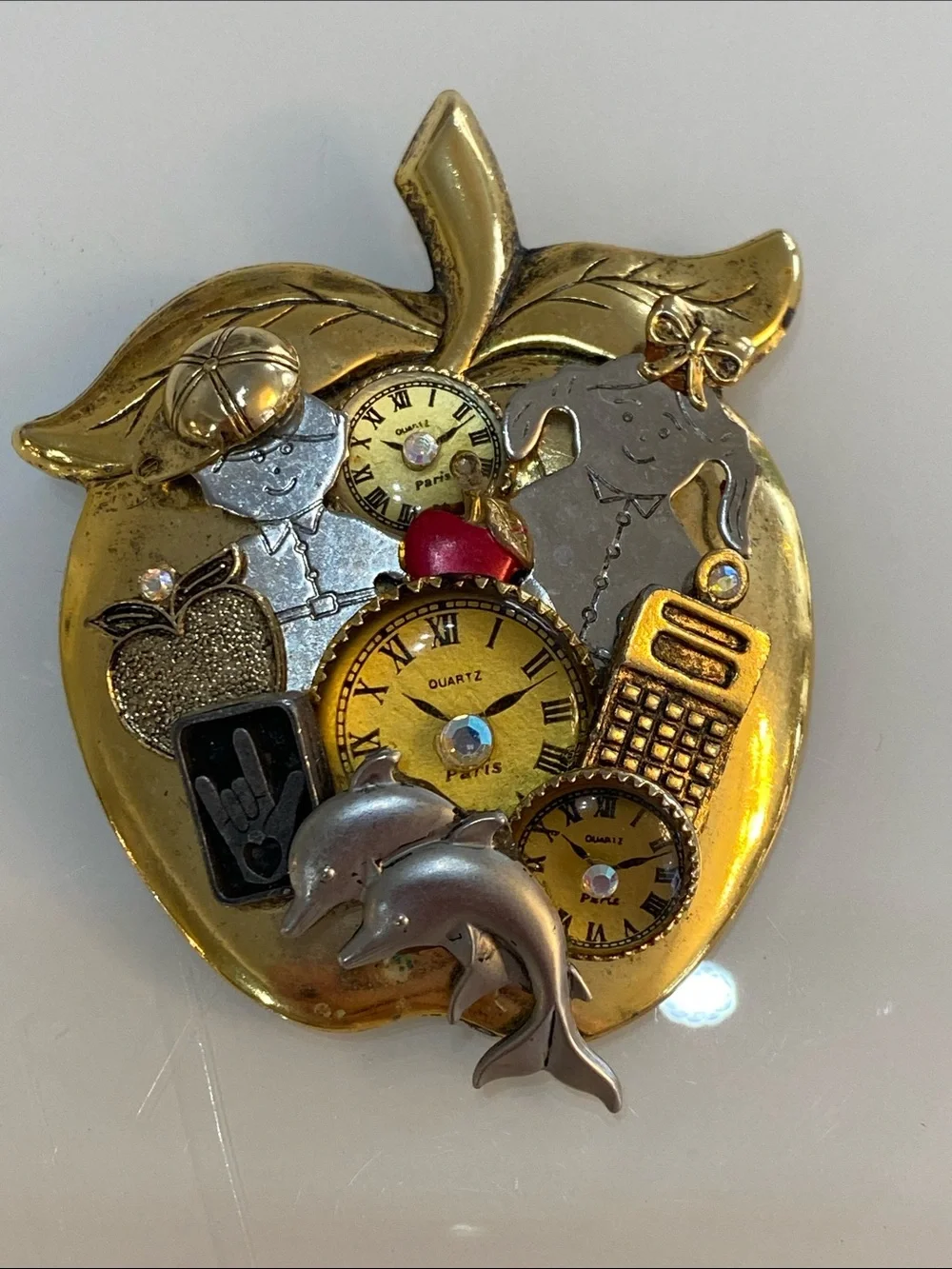 Gold-Tone Apple Collage Brooch with Clock Faces and Dolphin Accents